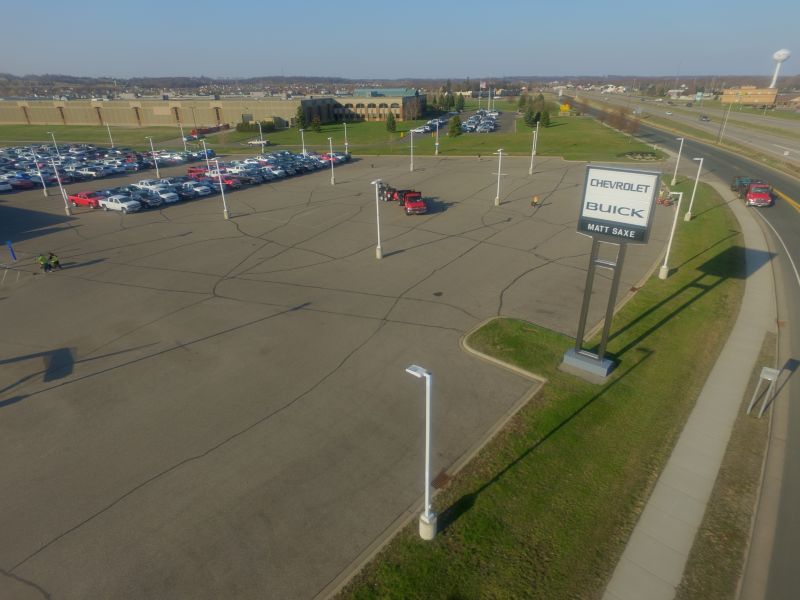 Before — Car Dealership Parking Lot – Belle Plaine